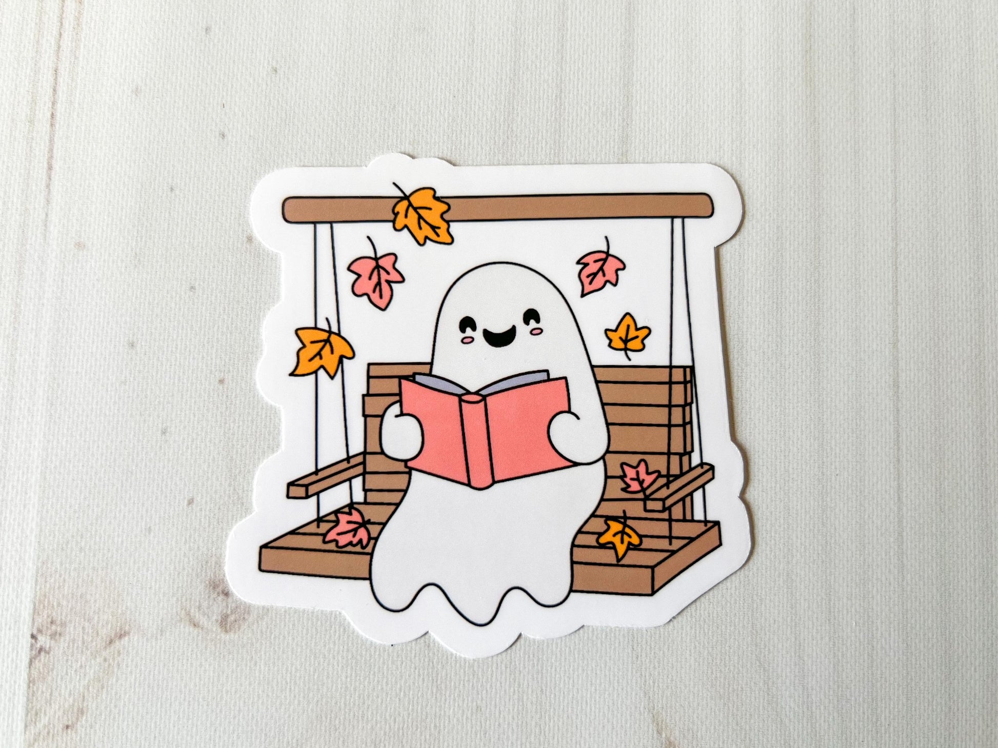 Ghost Reading on Porch Swing Fall Cozy Vinyl Sticker